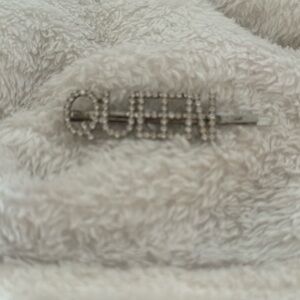 The size is os and a the color is silver and says queen can wear it anytime